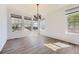 Bright dining room featuring hardwood floors, large windows, and modern lighting at 24763 E Crestridge Pl, Aurora, CO 80016