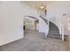 Inviting foyer with a grand staircase, neutral carpet, and open layout at 24763 E Crestridge Pl, Aurora, CO 80016