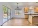 Open-concept kitchen and breakfast area featuring hardwood floors, and sliding glass doors at 24763 E Crestridge Pl, Aurora, CO 80016