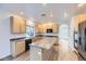 Spacious kitchen with wood cabinets, granite countertops, a center island, and stainless steel appliances at 24763 E Crestridge Pl, Aurora, CO 80016