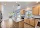 Well-appointed kitchen featuring wood cabinets, laminate countertops, and a breakfast bar at 24763 E Crestridge Pl, Aurora, CO 80016