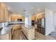 Well-lit kitchen with wood cabinets, a central island, stainless steel appliances, and hardwood floors at 24763 E Crestridge Pl, Aurora, CO 80016