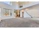 Spacious living room with high ceilings, staircase, and view to kitchen at 24763 E Crestridge Pl, Aurora, CO 80016