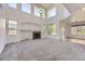 Bright living room with large windows, fireplace, and tall ceilings at 24763 E Crestridge Pl, Aurora, CO 80016