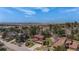 Expansive aerial view showcasing the home's location amidst mature trees, with lake and mountain views at 7965 Lakeshore Dr, Parker, CO 80134
