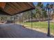 Large deck with awning, perfect for outdoor gatherings, featuring a hot tub and expansive lawn at 7965 Lakeshore Dr, Parker, CO 80134