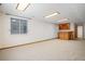 Finished basement rec room with carpet, natural light, and a built-in bar area with wood trim at 7965 Lakeshore Dr, Parker, CO 80134