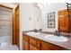 Bathroom with double sinks, a tiled countertop, and decorative framed mirrors at 7965 Lakeshore Dr, Parker, CO 80134
