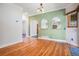 Sunny dining room with green accent wall, hardwood floors and decorative arched pass-through at 7965 Lakeshore Dr, Parker, CO 80134