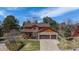 Beautiful two-story home with stone accents, a covered porch, an attached garage, and a lush green lawn at 7965 Lakeshore Dr, Parker, CO 80134