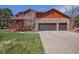 Charming two-story home featuring a stone facade, attached garage, covered porch, and well-maintained lawn at 7965 Lakeshore Dr, Parker, CO 80134