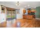 Bright kitchen and dining area with hardwood floors, wood cabinets, and a sliding door to the deck at 7965 Lakeshore Dr, Parker, CO 80134