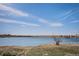 Scenic view of a calm lake with distant mountains, offering a serene and picturesque landscape at 7965 Lakeshore Dr, Parker, CO 80134