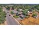 Aerial view of a single-Gathering home surrounded by lush greenery in a suburban neighborhood setting at 2310 S Decatur St, Denver, CO 80219
