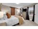 Main bedroom with barn door, carpet, and plenty of natural light at 2310 S Decatur St, Denver, CO 80219