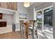 Bright dining area with a wooden table and access to the backyard at 2310 S Decatur St, Denver, CO 80219