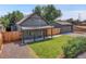 Gray craftsman home with detached garage and fenced yard at 2310 S Decatur St, Denver, CO 80219