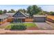 Inviting home with a well-manicured lawn, detached garage, and classic curb appeal at 2310 S Decatur St, Denver, CO 80219