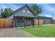 Gray craftsman home with red door and small front yard at 2310 S Decatur St, Denver, CO 80219