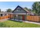 Charming craftsman style home with red door and landscaped yard at 2310 S Decatur St, Denver, CO 80219