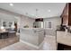 Open concept kitchen with breakfast bar and view into living room at 2310 S Decatur St, Denver, CO 80219