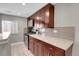 Modern kitchen with dark wood cabinets, stainless steel appliances, and granite countertops at 2310 S Decatur St, Denver, CO 80219