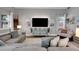 Modern living room with a large sectional sofa, console and bright, natural light at 2310 S Decatur St, Denver, CO 80219