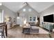 Vaulted ceiling living room with L-shaped sofa and wood floors at 2310 S Decatur St, Denver, CO 80219