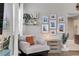 Cozy living room with designer chair, styled shelves and gallery wall of framed photos at 2310 S Decatur St, Denver, CO 80219