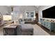 Open-concept living room with vaulted ceiling, L-shaped sofa and large screen television at 2310 S Decatur St, Denver, CO 80219