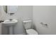 Cozy half-bath featuring pedestal sink, neutral color palette and modern fixtures at 681 N Tempe St, Aurora, CO 80018