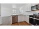 Stylish kitchen with stainless steel appliances, granite counters, and modern white cabinetry at 681 N Tempe St, Aurora, CO 80018