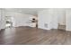 Open-concept living room and kitchen space with modern flooring and bright white walls at 681 N Tempe St, Aurora, CO 80018