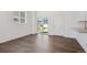 Sunlit living room featuring wood-look flooring, white walls, and sliding door access at 681 N Tempe St, Aurora, CO 80018