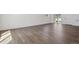 Bright living room featuring wood-look flooring, white walls, and natural light at 681 N Tempe St, Aurora, CO 80018