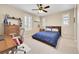 Cozy bedroom featuring a ceiling fan, a study desk and chair, with plenty of natural light from multiple windows at 14672 Melco Ave, Parker, CO 80134