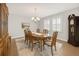 Elegant dining room with hardwood floors, shuttered windows and classic chandelier lighting at 14672 Melco Ave, Parker, CO 80134