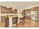 Beautiful kitchen with stainless appliances, granite countertops, an island, and wood floors at 14672 Melco Ave, Parker, CO 80134