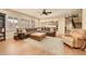 Spacious living room with hardwood floors, a large sectional, and views into the kitchen at 14672 Melco Ave, Parker, CO 80134