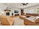 Comfortable living room featuring a fireplace, a large sectional, and plenty of natural light at 14672 Melco Ave, Parker, CO 80134