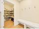 Walk-in pantry with ample shelving and storage space, plus a convenient bench and coat hooks at 14672 Melco Ave, Parker, CO 80134
