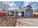Backyard featuring a covered patio, well-maintained lawn, and a detached garage at 4280 S Pearl St, Englewood, CO 80113