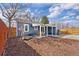 Backyard featuring a covered patio, fire pit and well-maintained landscaping with a small pond at 4280 S Pearl St, Englewood, CO 80113