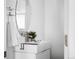 Bright bathroom features a modern vanity with a stylish oval mirror and clean, minimalist design at 4280 S Pearl St, Englewood, CO 80113