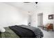 Comfortable bedroom features a modern chair, a closet, vaulted ceilings and neutral colors at 4280 S Pearl St, Englewood, CO 80113