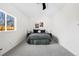 This cozy bedroom has gray carpet, a vaulted ceiling, and a double bed with two black nightstands at 4280 S Pearl St, Englewood, CO 80113