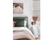 This bedroom features a vase on a side table with a gray headboard and plush throw pillows and blankets at 4280 S Pearl St, Englewood, CO 80113