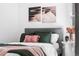This bright bedroom features modern decor and a plush, comfortable bed with assorted throw pillows and blankets at 4280 S Pearl St, Englewood, CO 80113