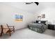 Cozy bedroom boasts a comfortable bed, side table and a bright window at 4280 S Pearl St, Englewood, CO 80113