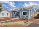 Inviting home exterior with a cozy bench, xeriscaping, and a well-manicured lawn at 4280 S Pearl St, Englewood, CO 80113